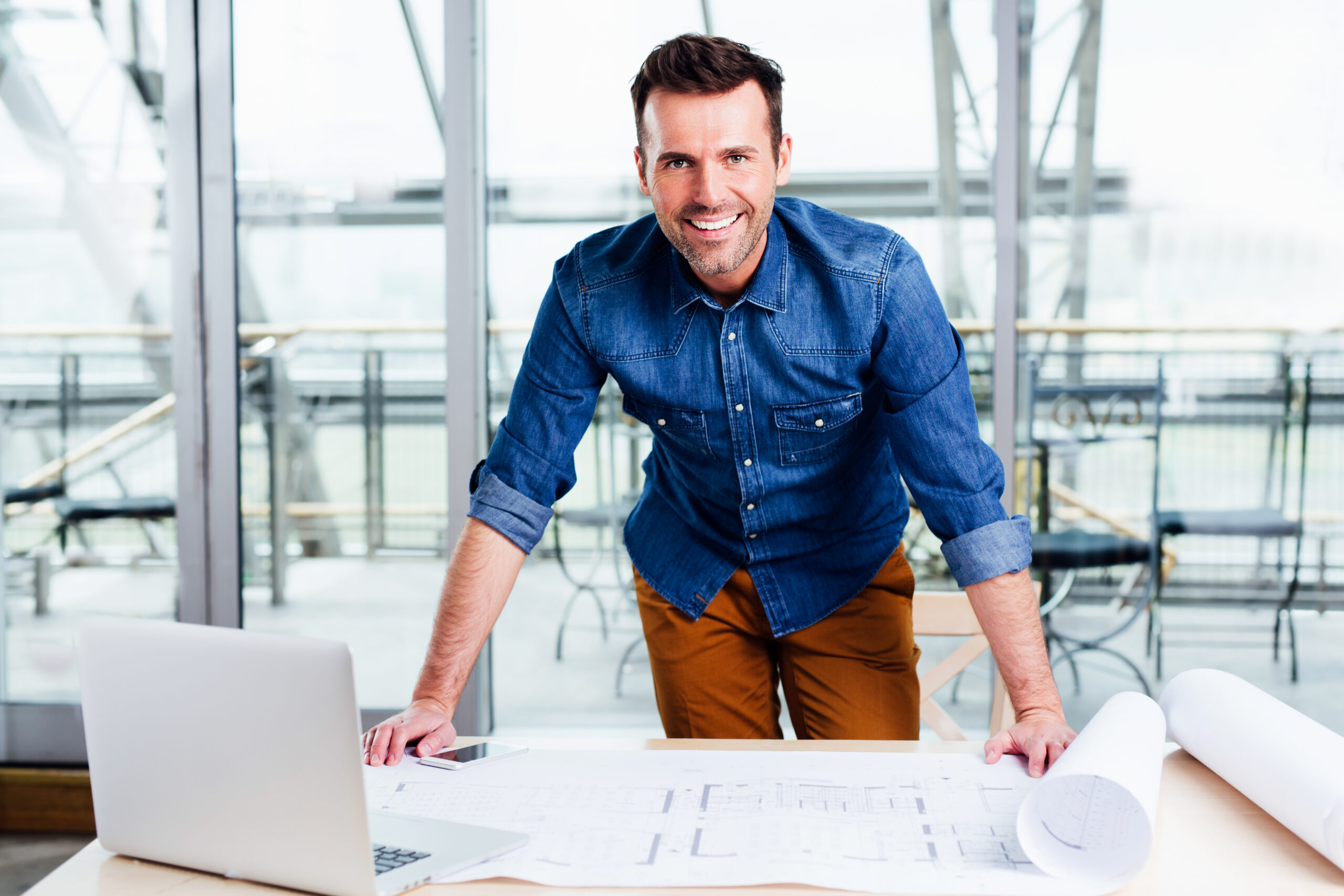 Business owner reviewing plans with expert IT services supporting their operations.