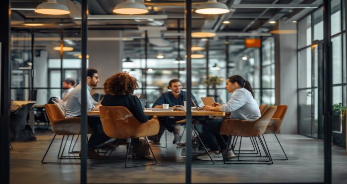 Small business team collaborating to overcome IT challenges with Mentis Group managed IT services in Dallas–Fort Worth office setting.