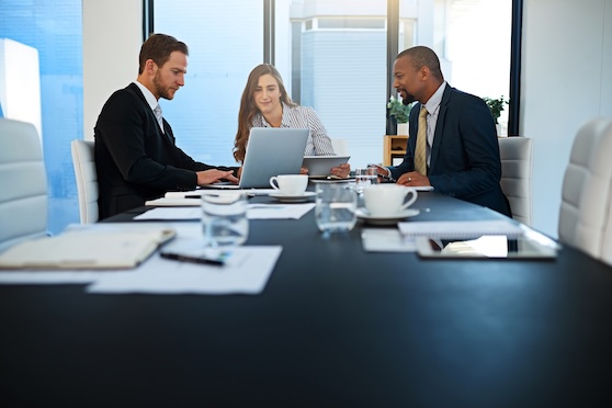 IT Services for Law Firms in Dallas–Fort Worth | Mentis Group Attorneys collaborating in a modern conference room using secure digital tools, representing IT services for law firms in Dallas–Fort Worth.